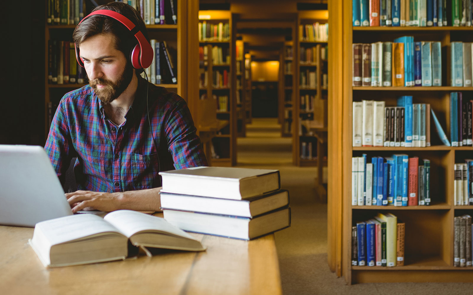 Man in library working on computer