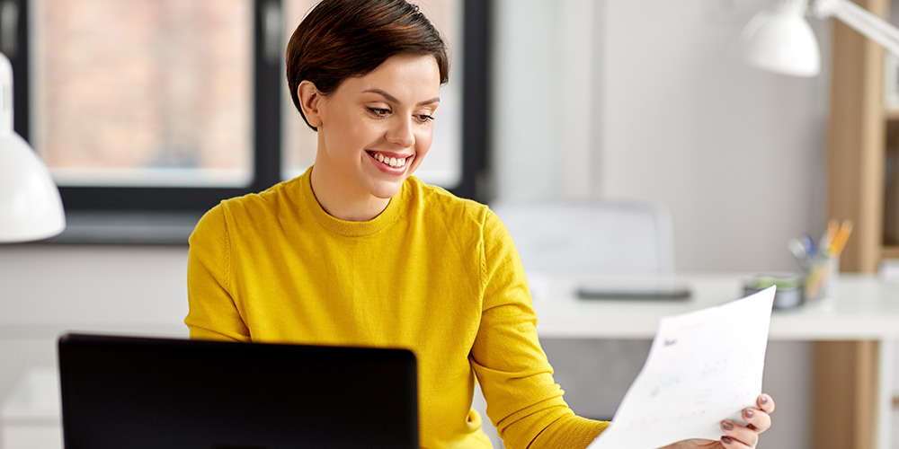 Business woman at her desk talking on the phone