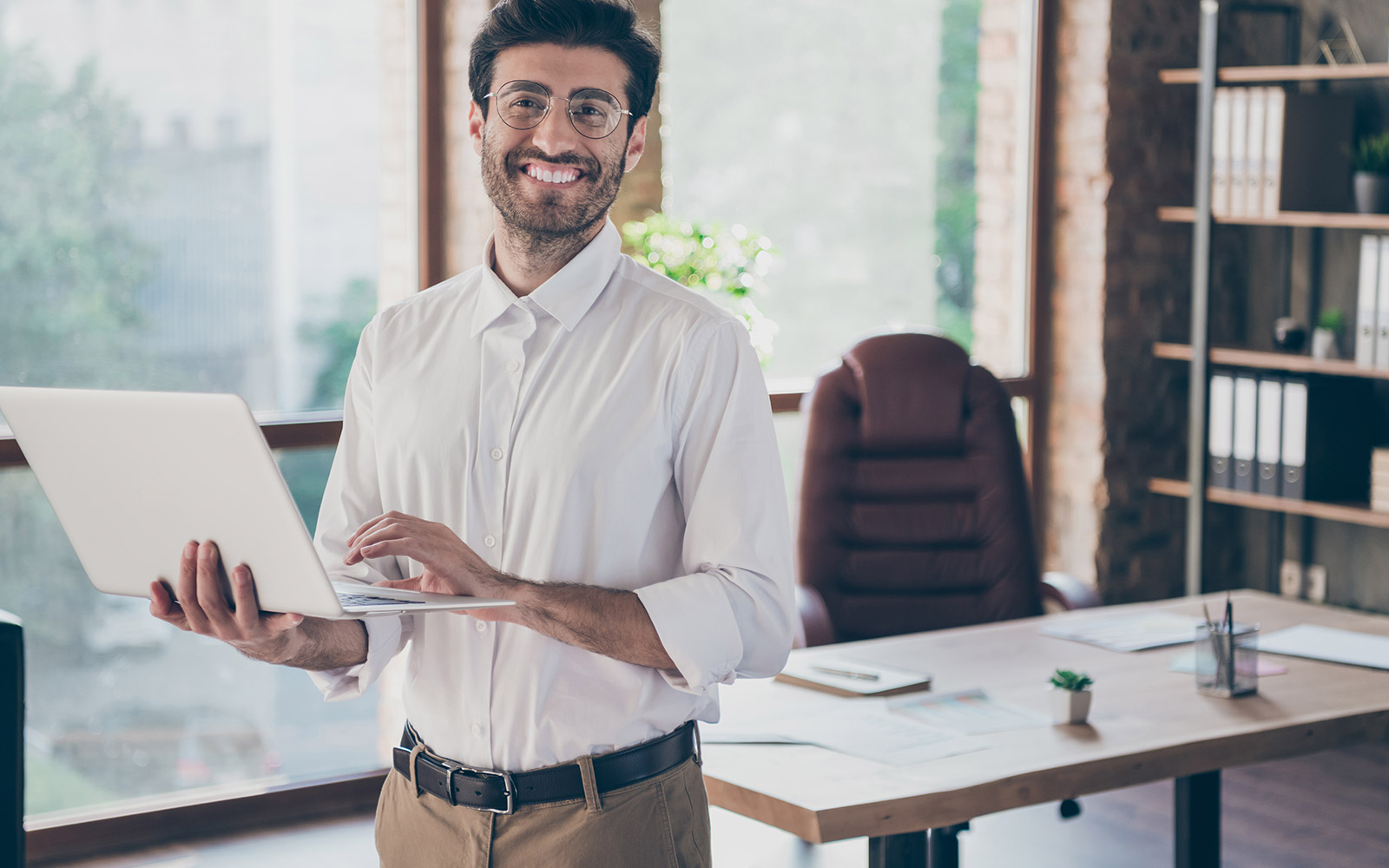 Financial advisor holding a laptop