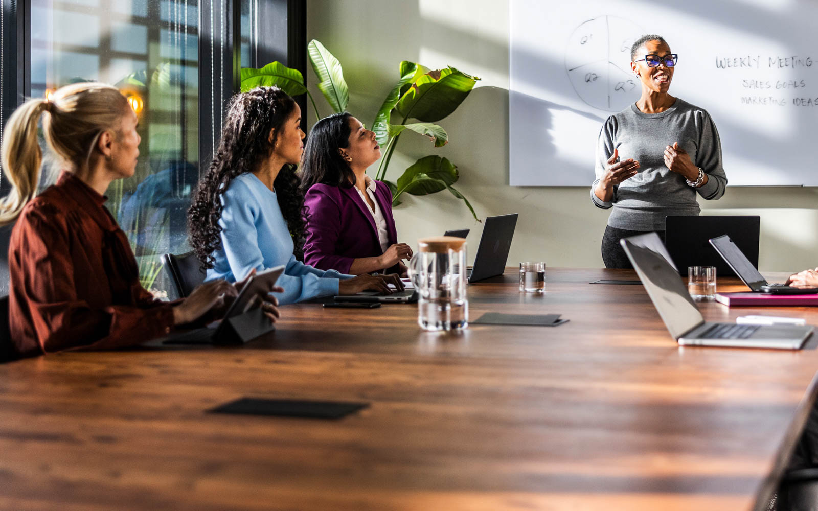 Marketing students collaborating in a business meeting setting.