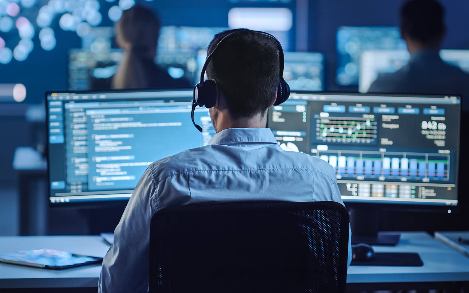 Cyber security engineers working on their dual monitor computer