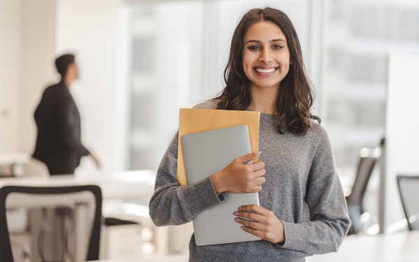 Woman holding books smiling
