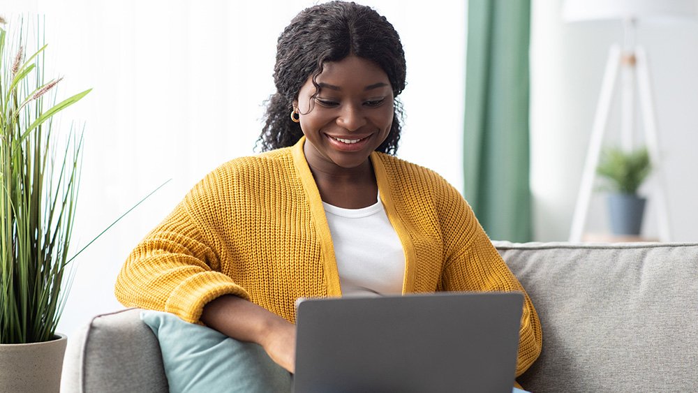Woman smiling at laptop