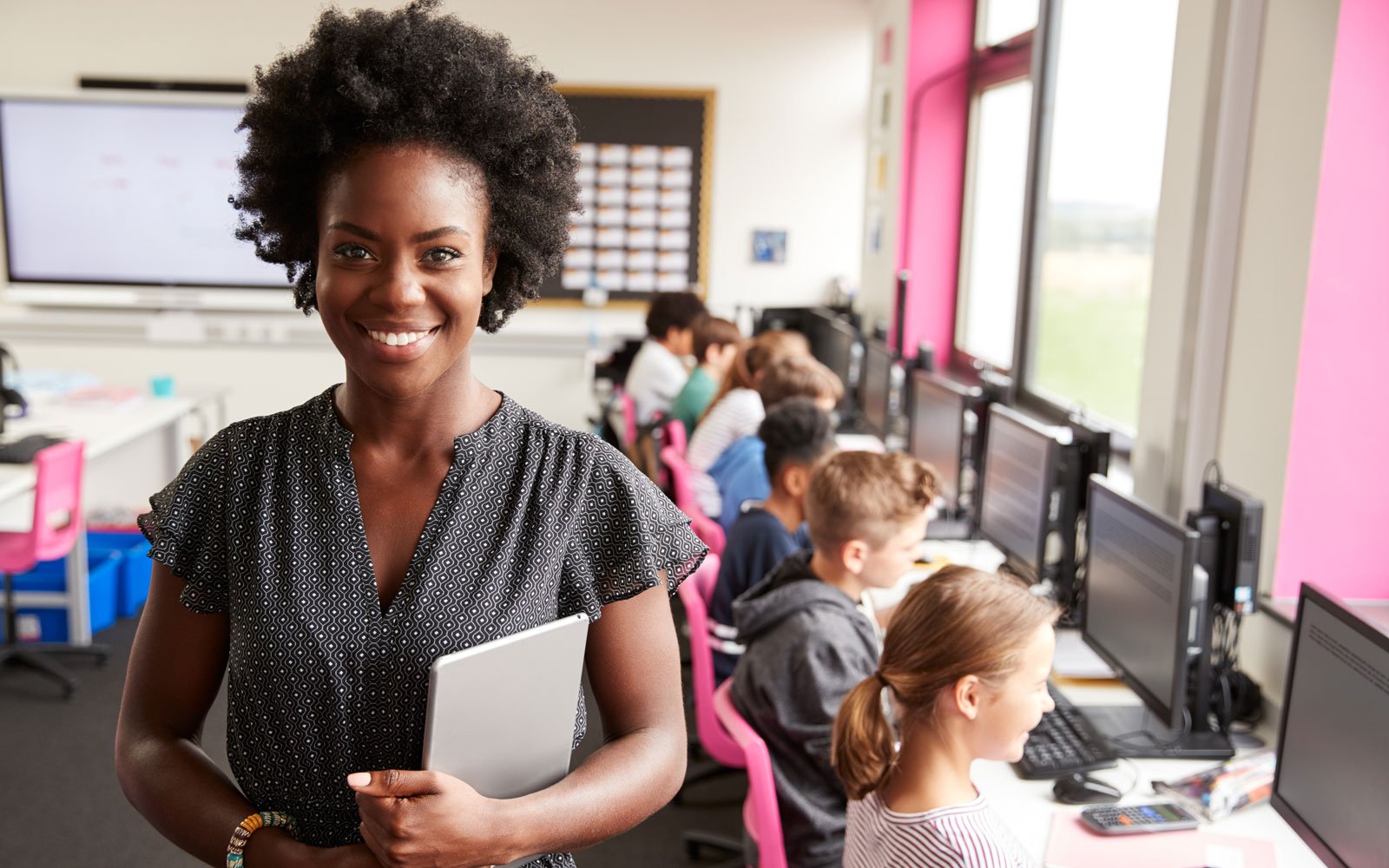 Teacher in computer class with kids