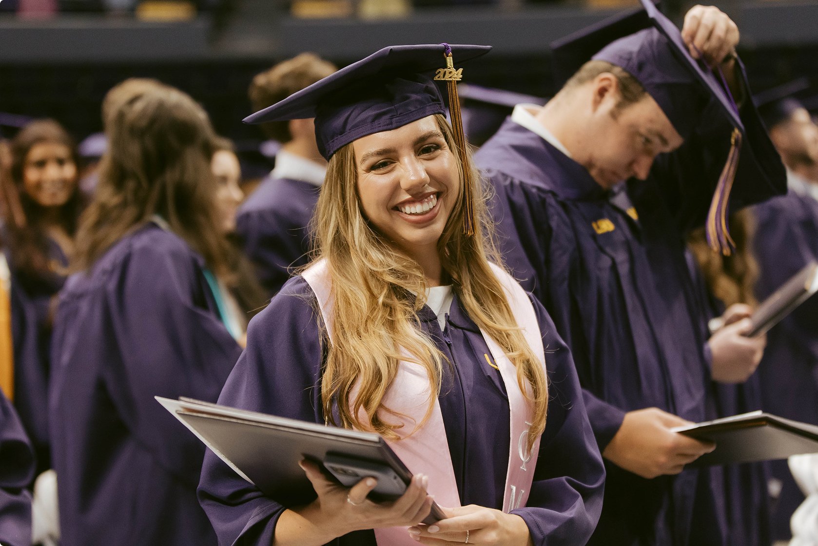LSU grad smiling at camera.