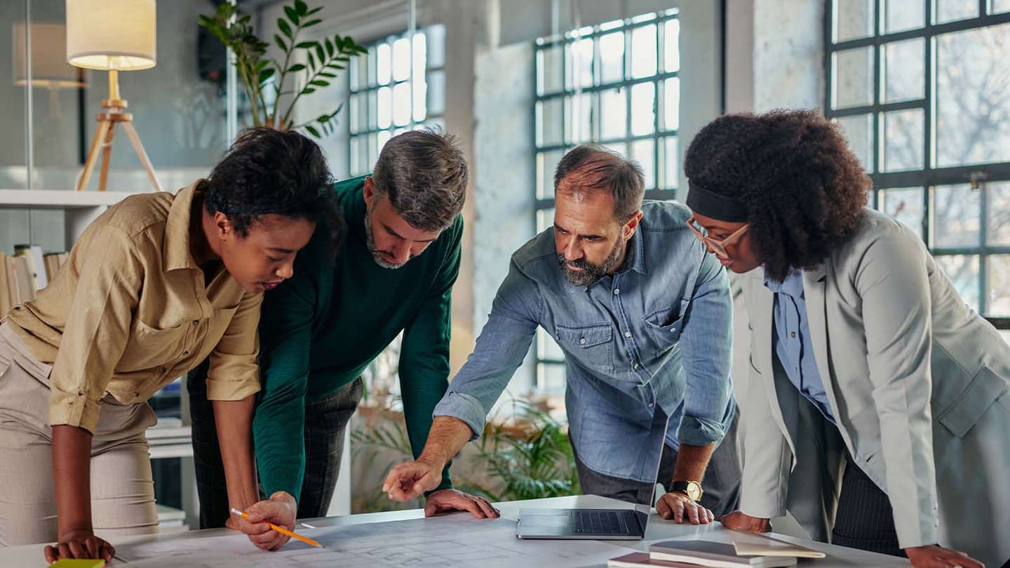 Group of people looking over documents on table