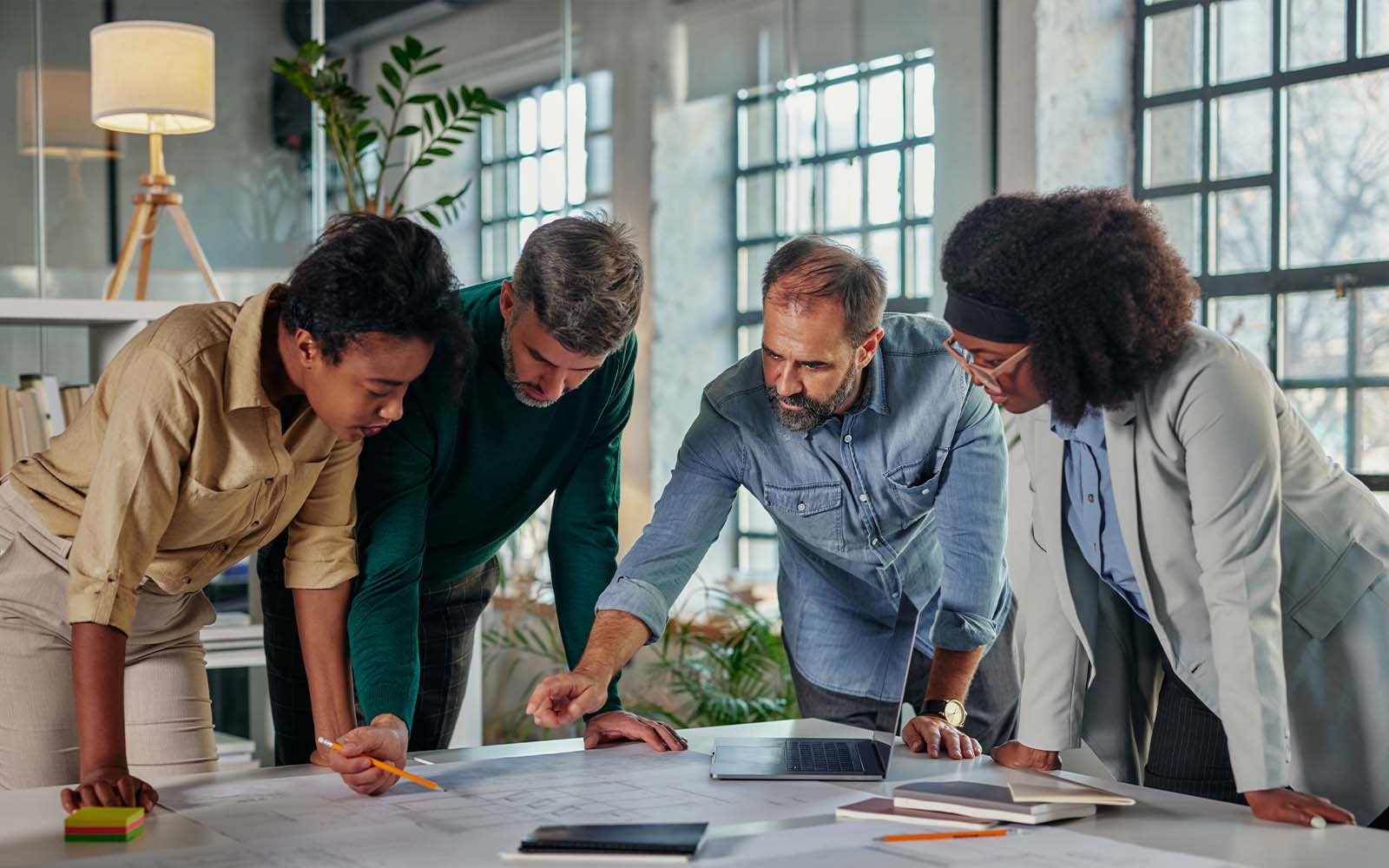 Group of people looking over documents on table