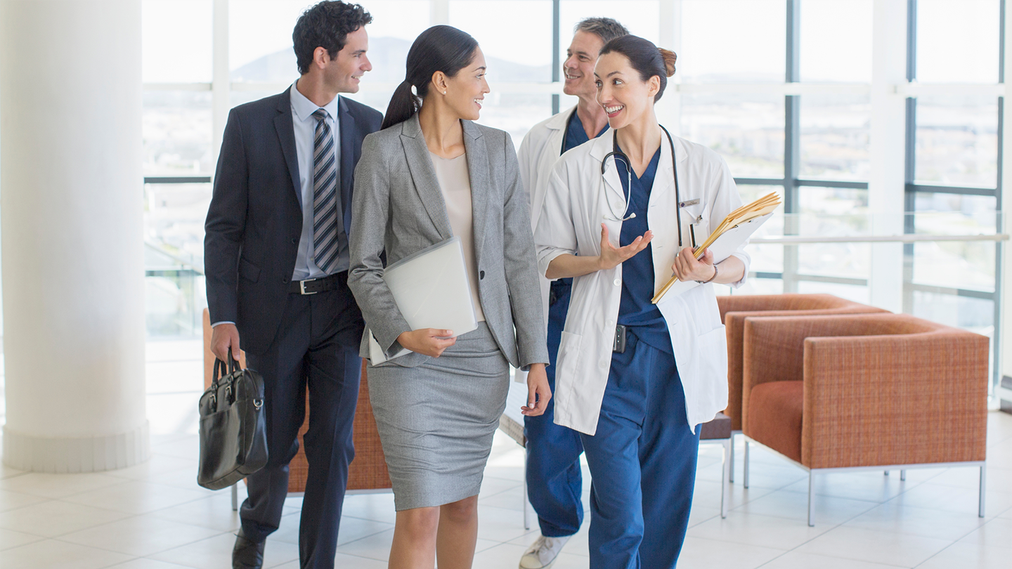 Healthcare professionals walk down hallway