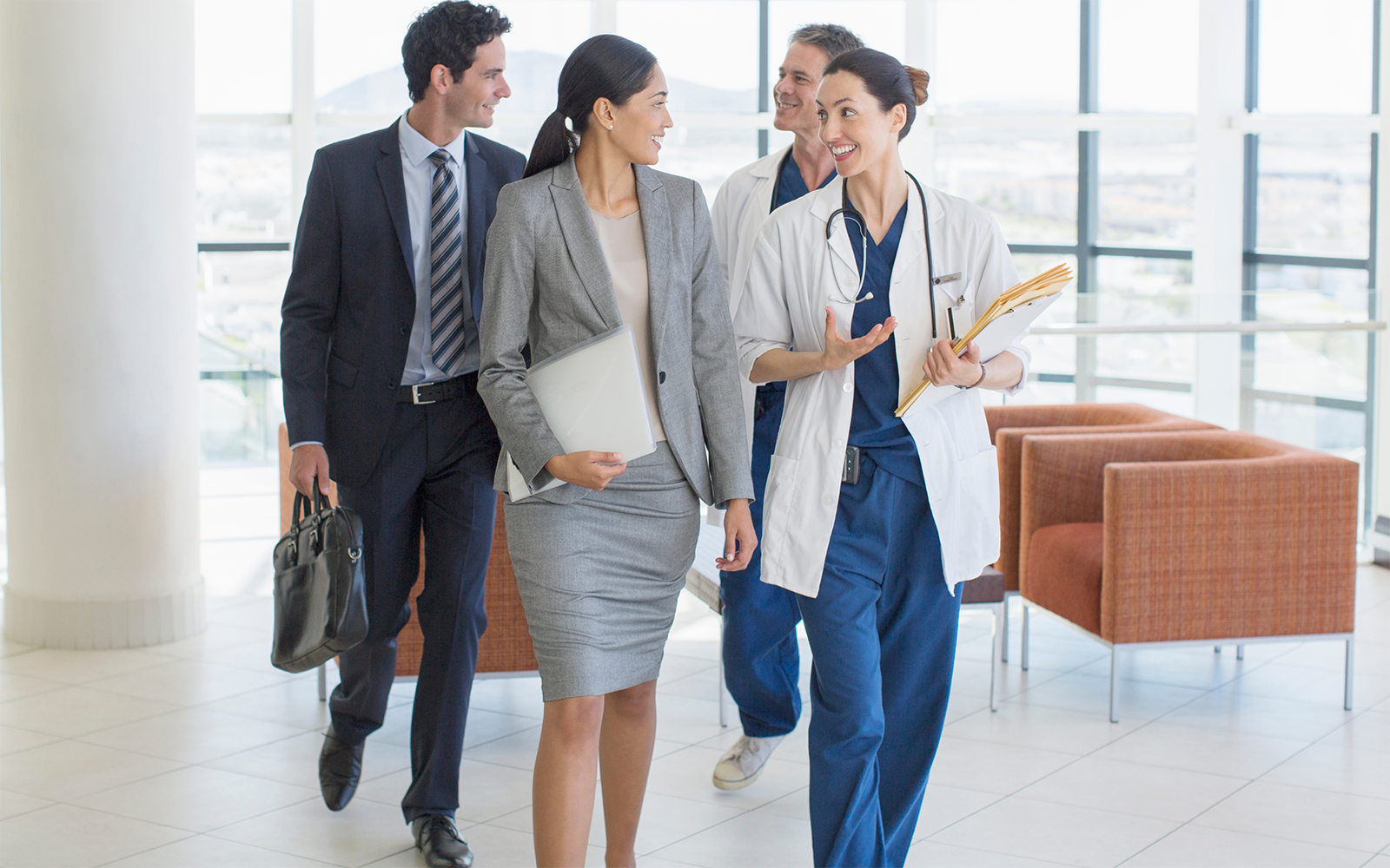 Healthcare professionals walk down hallway