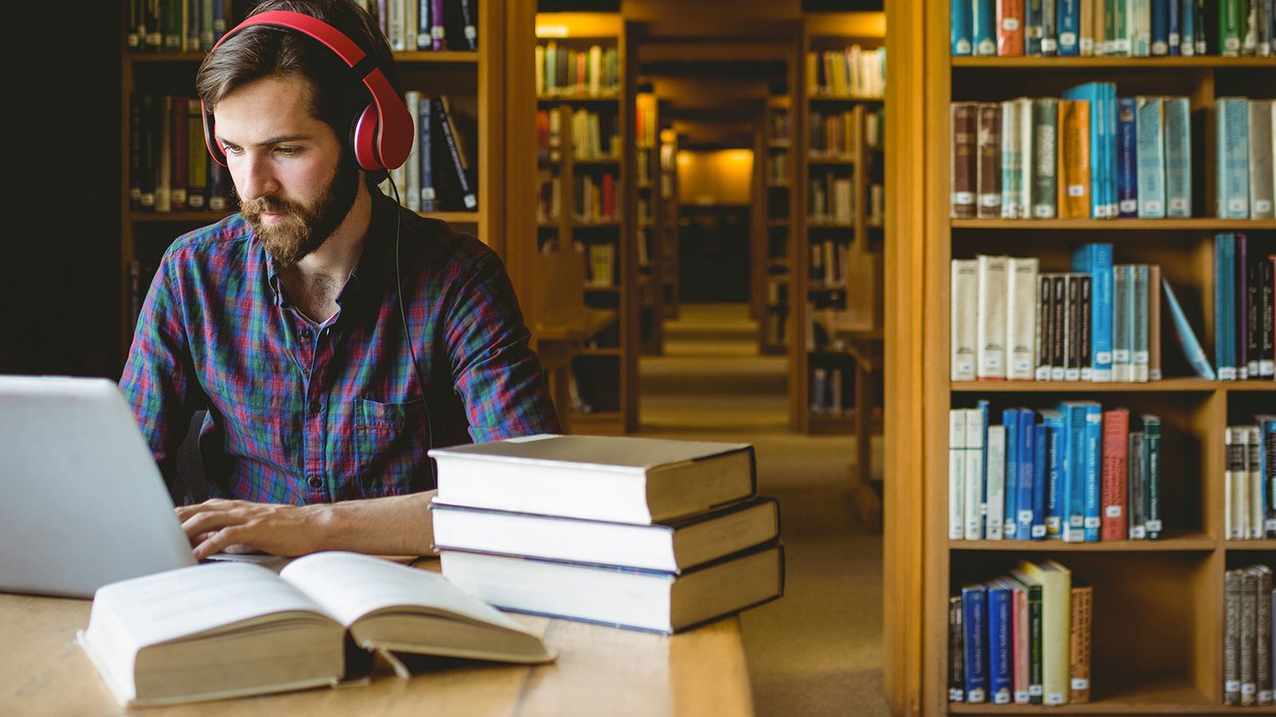 Man in library working on computer