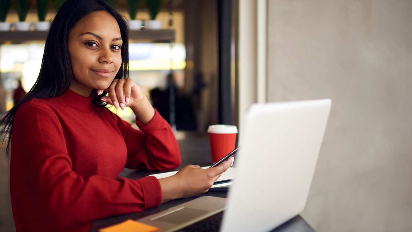 Women working at coffee shop on computer