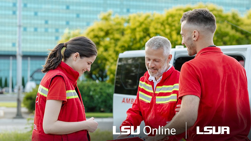 Ambulance personnel smiling at a clipboard