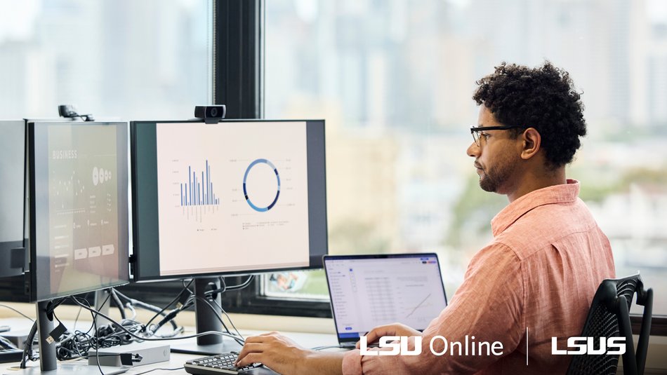 Man working in finance sitting at desk reviewing graphs and charts on computer monitors.