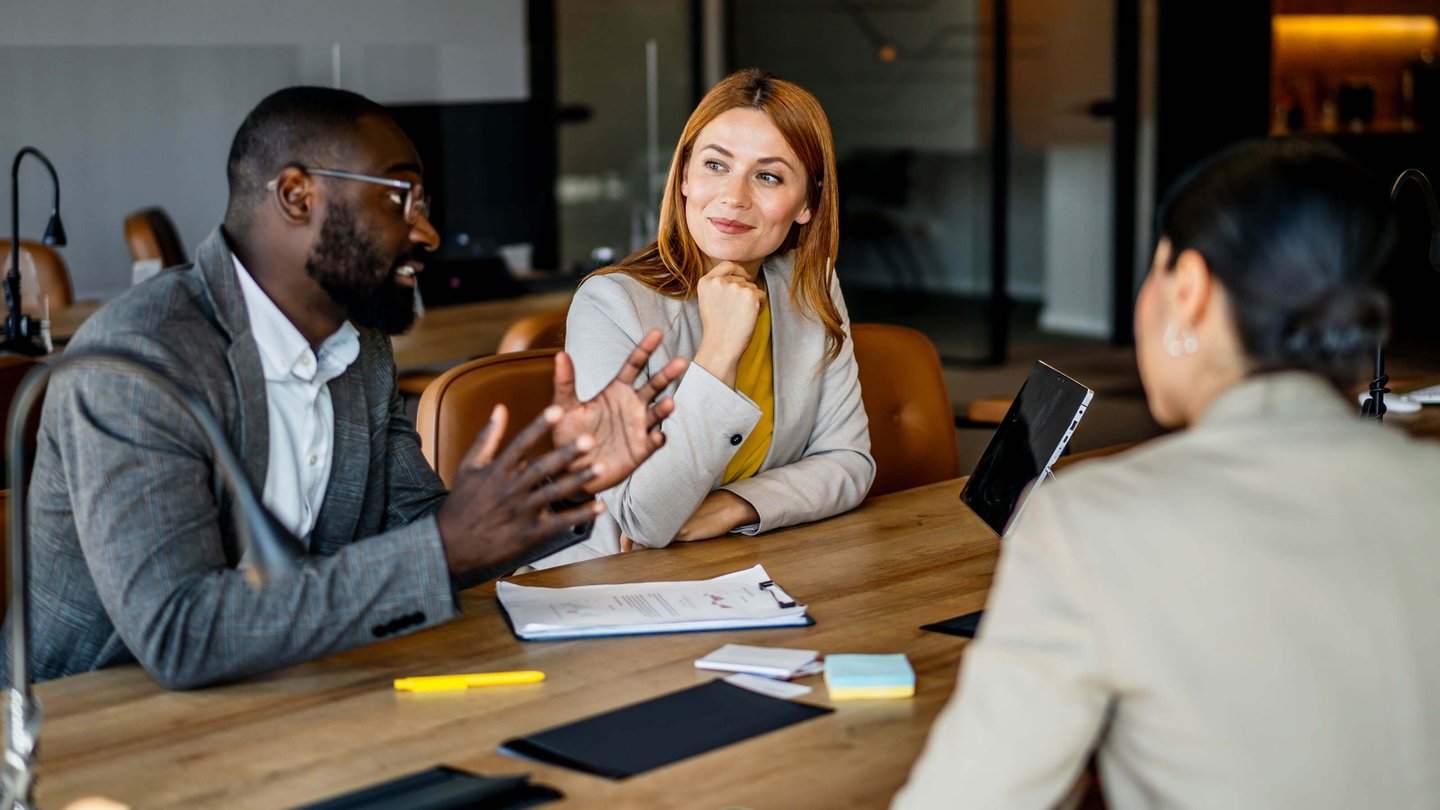 A group of marketing professionals discussing in a meeting