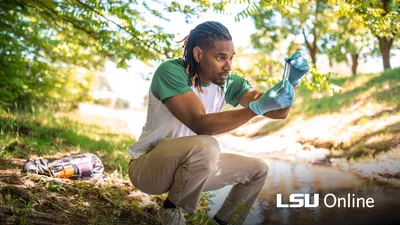 Environmental Science student gathering water test samples at a river
