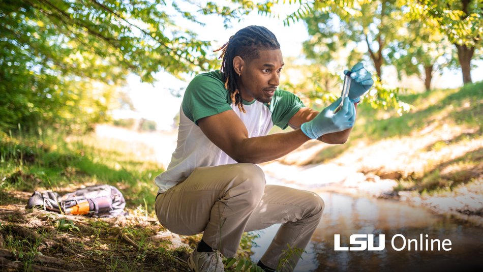 Environmental Science student gathering water test samples at a river