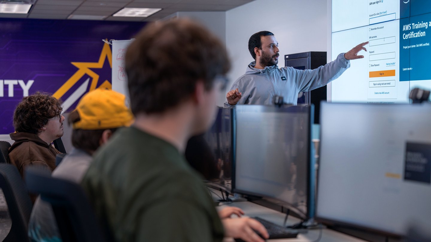 Instructing students in front of large screen