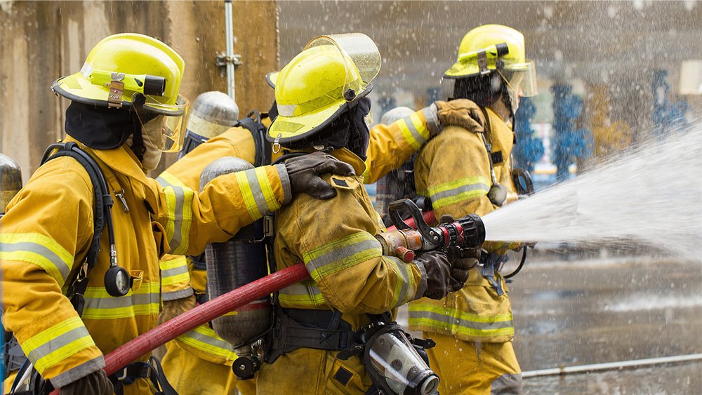 Fire personnel spraying a fire hose