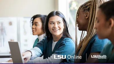 Nurse education students discussing studies on a laptop