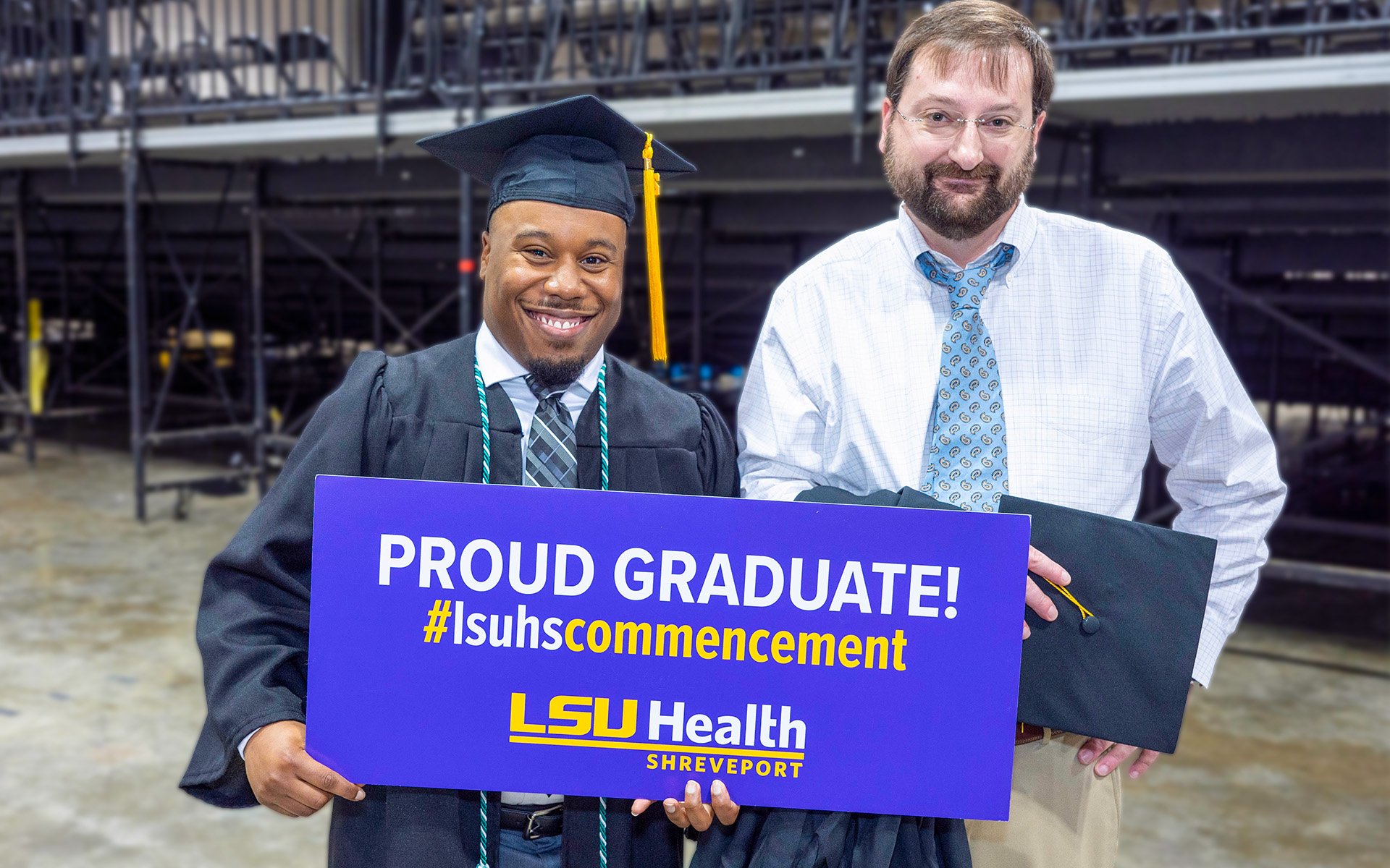 Proud LSUHS graduate standing with one of his professors.
