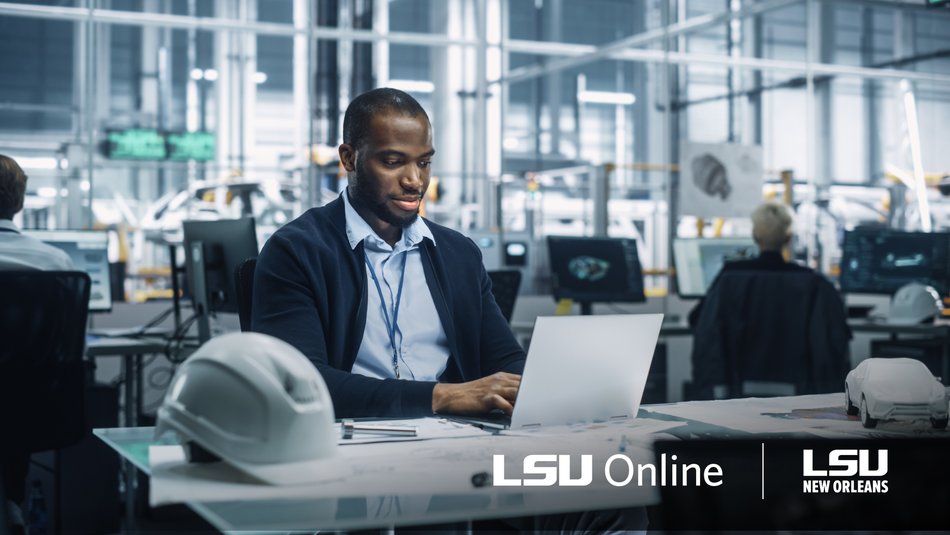 Engineering manager reviewing work on laptop