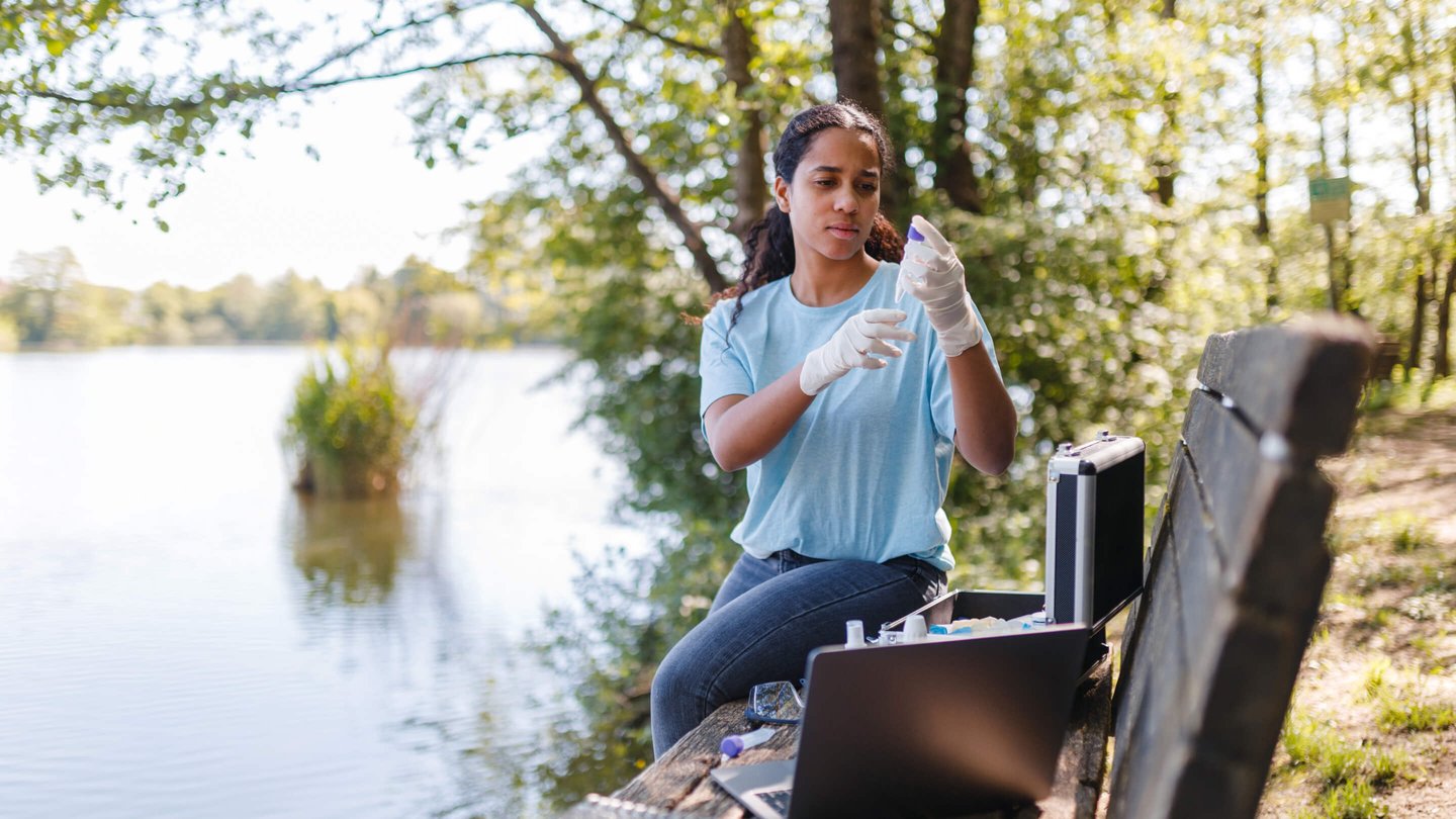 Woman testing water outside