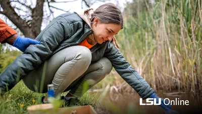 Environmental Science student gathering river water in a tube