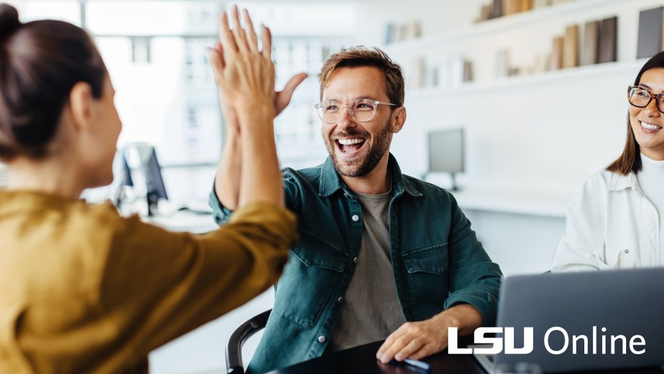 Team high fiving in office