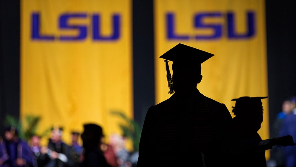 Silhouette of graduate in front of LSU Banners