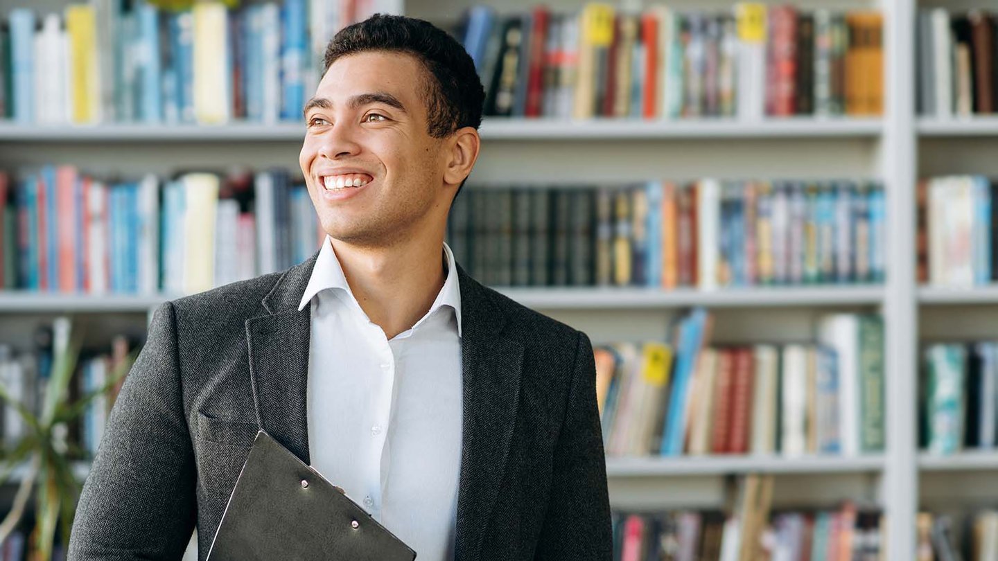 Bachelor student walking through library