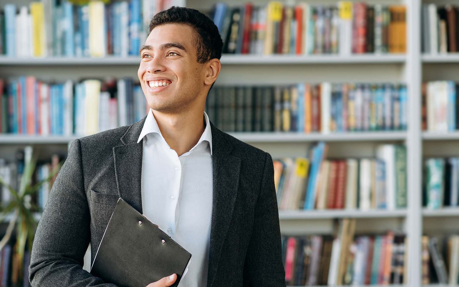 Bachelor student walking through library