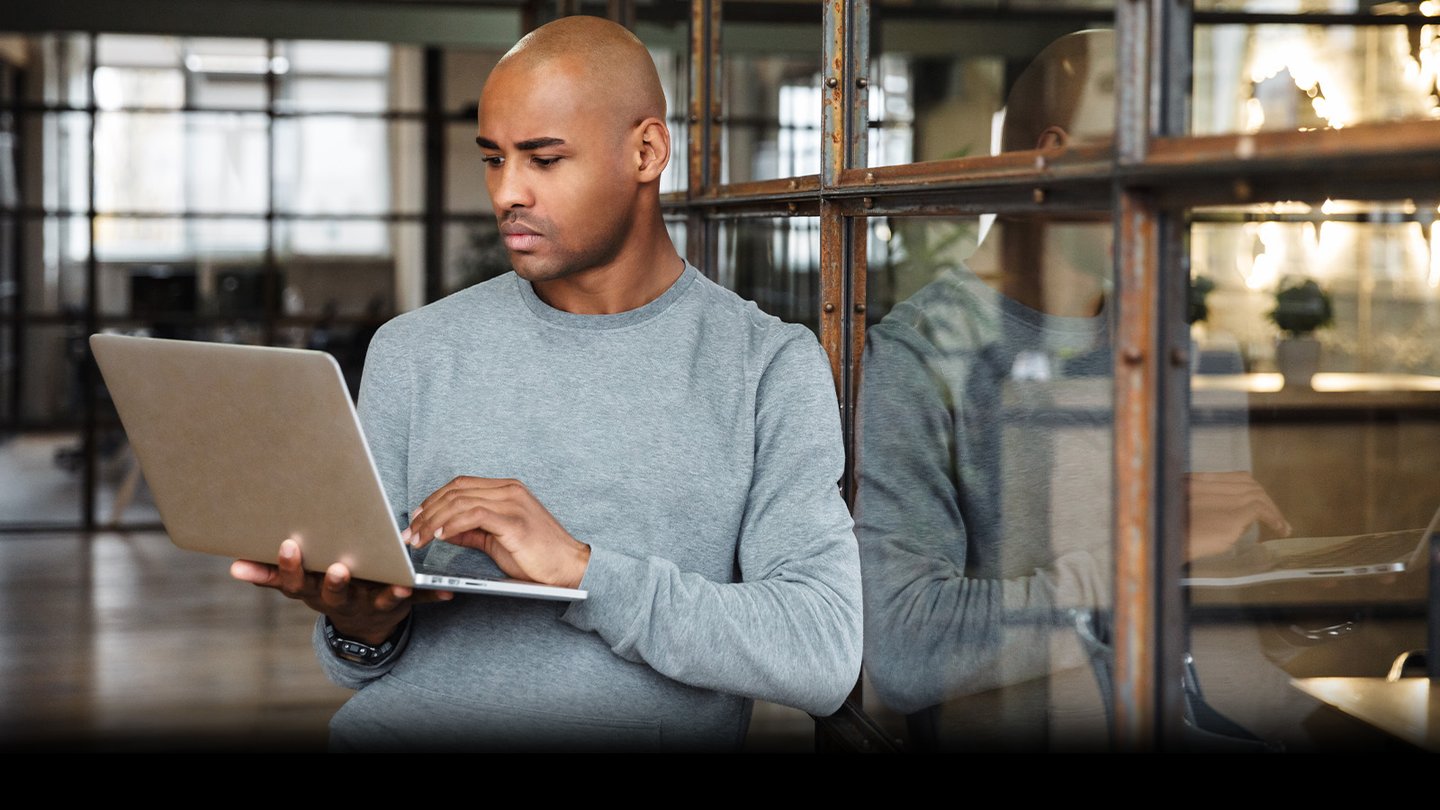 Man using laptop in doorway