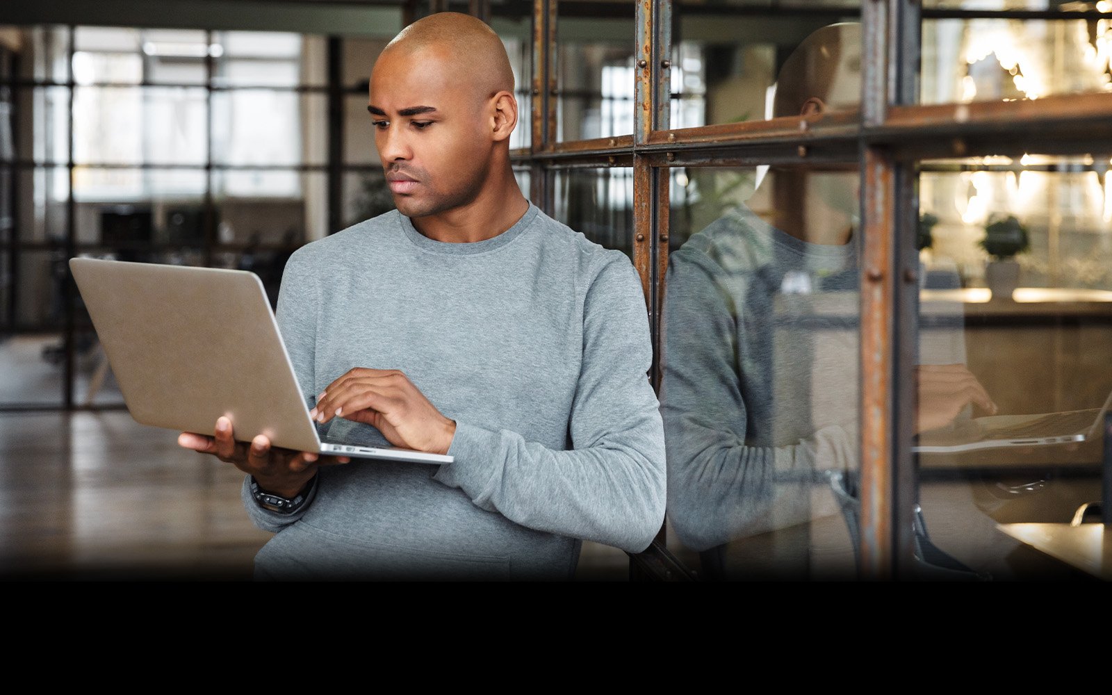 Man using laptop in doorway