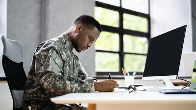 Military man working at a desk