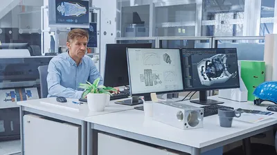 Construction manager reviewing plans on his computer