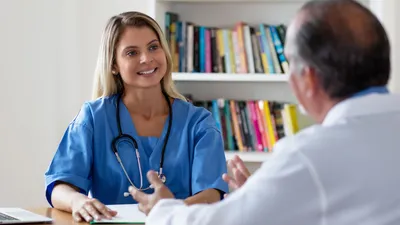 Nurse talking with doctor.