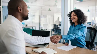 Male Human Resources Specialist Shaking Hands With Female Employee