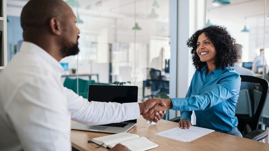 Male Human Resources Specialist Shaking Hands With Female Employee