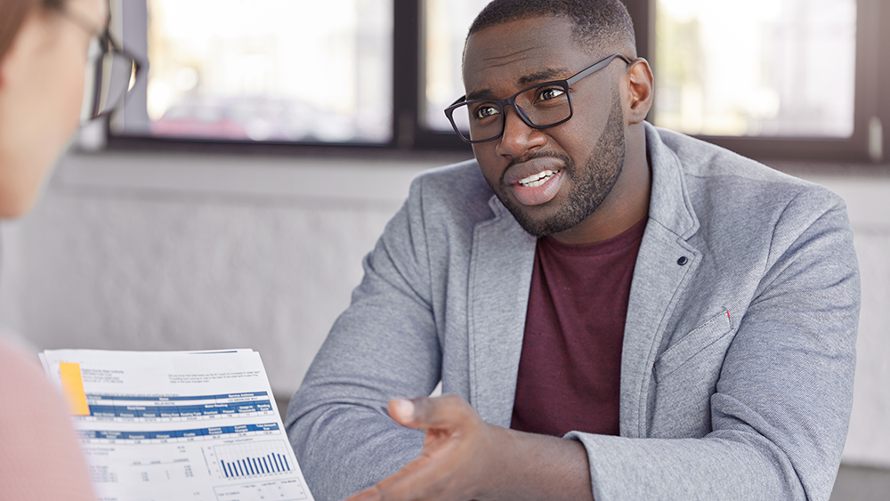 Accountant explaining financial documents to customer