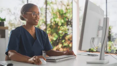 Health professional sitting in front of a computer