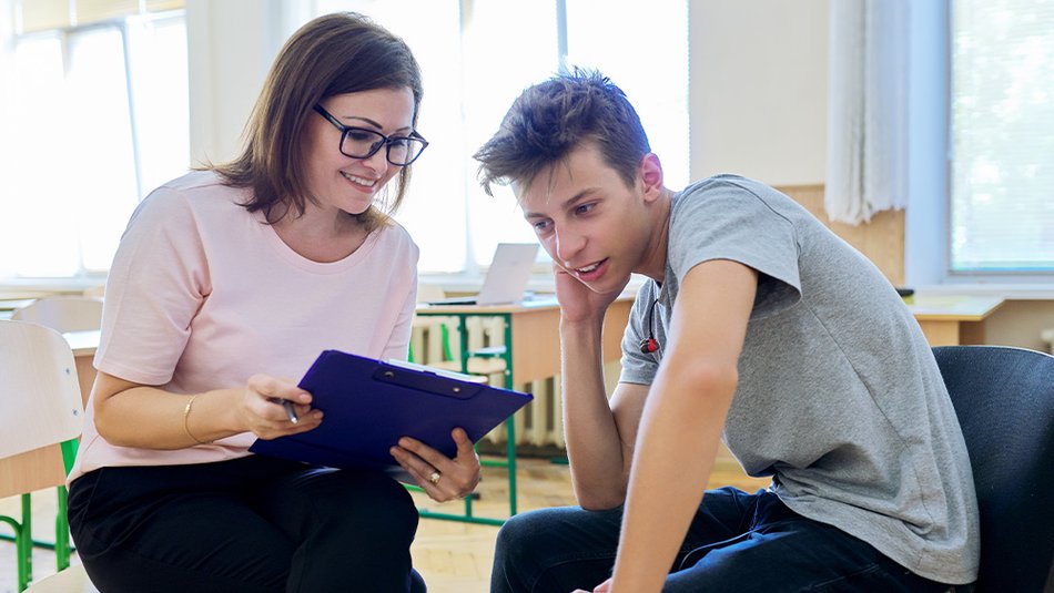 Social worker woman showing documents to a teenager