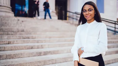 Professional woman standing in front of building