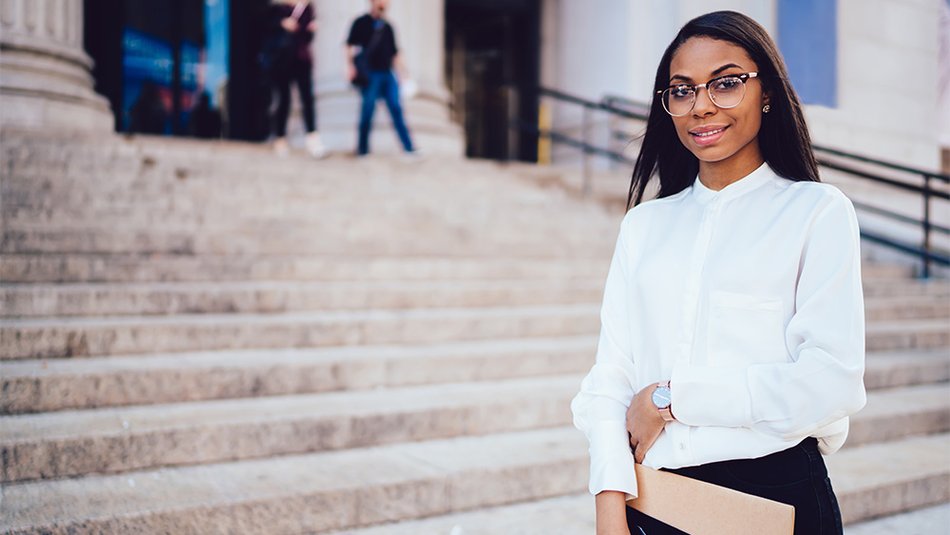 Professional woman standing in front of building