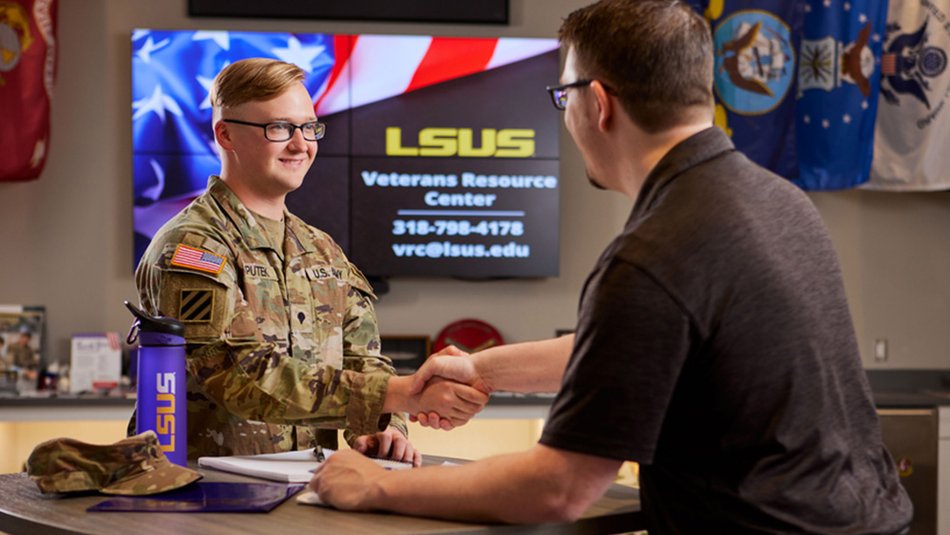 Man shaking hands with army personnel