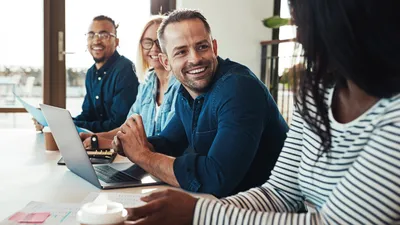 Man Over Laptop Utilizing Business Soft skills with his fellow workers