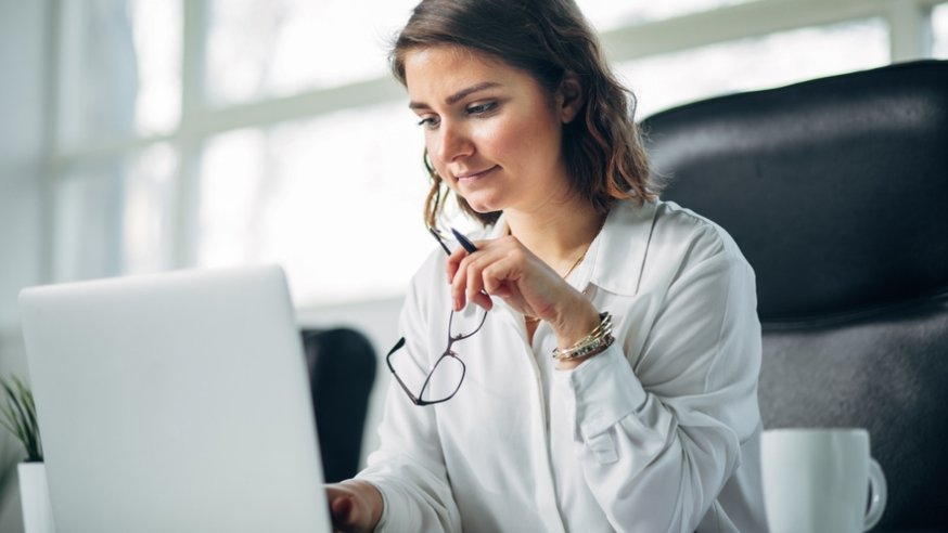 woman looking at a laptop- working on public administration