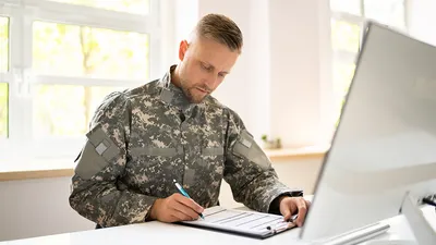 Military man working at computer