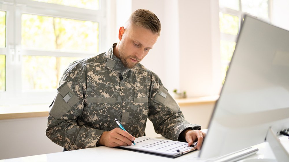 Military man working at computer