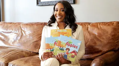 LSUS Online graduate holding books