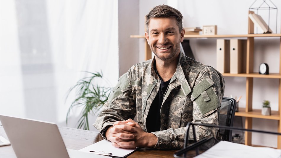 Military service member in front of laptop